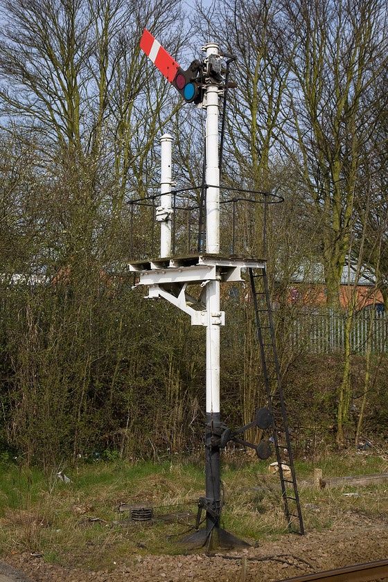 Down starter bracket, Creswell station 
 The down starter bracket, devoid of the lower submissive arm, at Creswell. The signal is pulled off but not for a train but as the box was switched out. The removed lower arm controlled access to a short spur that joined to a myriad of lines at Staveley colloquially known as the Clowne Branch. 
 Keywords: Down starter bracket Creswell station