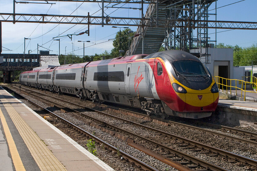 390152 10.23 London Euston-Birmingham New Street (1G14), Northampton station 
 A diverted Virgin West Coast train makes its way sedately through Northampton station working the 10.23 Euston to Birmingham New Street service. It is passing under the gargantuan temporary passenger footbridge that links the platforms whilst the station undergoes complete redevelopment. 
 Keywords: 390152 10.23 London Euston-Birmingham New Street 1G14 Northampton station Virgin Pendolino