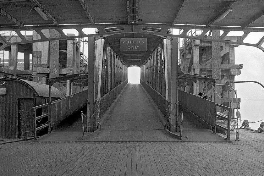 Loading ramp, New Holland Pier 
 Graham and I went to the far seaward end of New Holland pier to explore its operations a little further. In this view, taken from the loading ramp the access ramp from the pier is seen complete with enamel signage. Cars wishing to join the ferry would make their way down the ramp seen and wait to join the ferry from the side off to the right. 
 Keywords: Loading ramp New Holland Pier