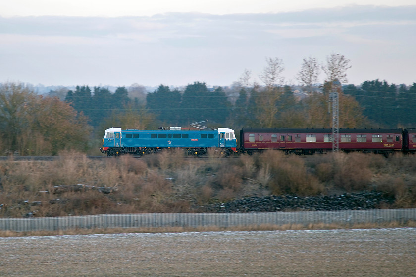 86259, outward leg of the Winter Cumbrian Mountain Express, 07.10 London Euston-Carlisle (1Z86), Bugbrooke SP673563 
 Veteren AC electric 86259 'Les Ross' (on this side at least!) leads the first of this year's Cumbrian Mountain Express' past a very cold Bugbrooke on the Weedon loop line. This 1Z86 excursion left Euston at 07.10 and then headed all the way to Carnforth. Here, 61306 'Mayflower' and 35018 'British India Line' took over for the climb over Shap to Carlisle followed by a return trip over the Settle and Carlisle route. 
 Keywords: 86259 Winter Cumbrian Mountain Express 07.10 London Euston-Carlisle 1Z86 Bugbrooke SP673563