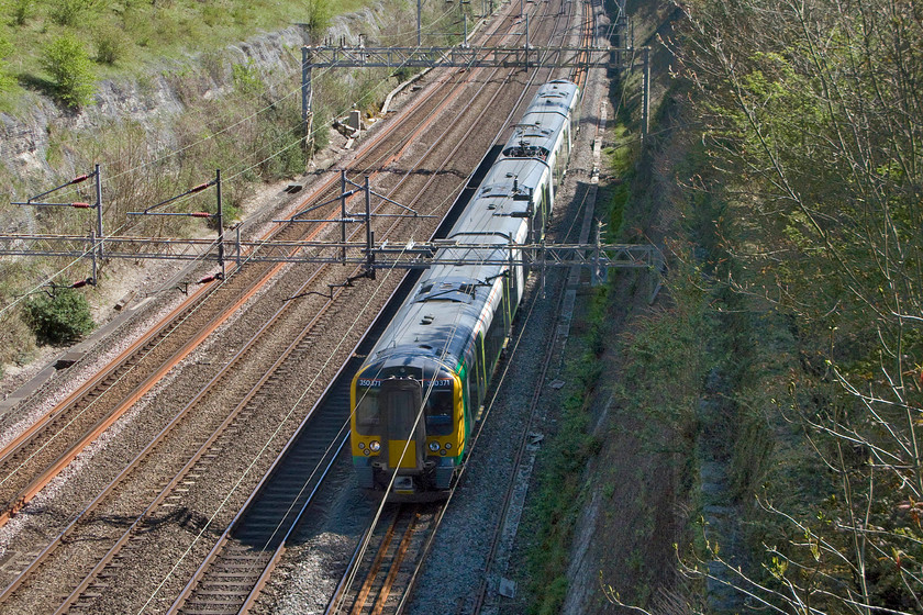 350371, LM 13.46 London Euston-Crewe (1U37), Roade cutting 
 350371 forms the 13.46 Euston to Crewe 'fast' service through Roade cutting. These London Midland operated services run fast as far as Stoke-on-Trent and then, effectively, as a stopper to Crewe via Kidsgrove and Alsager. 
 Keywords: 350371 13.46 London Euston-Crewe 1U37 Roade cutting London Midland Railway Desiro