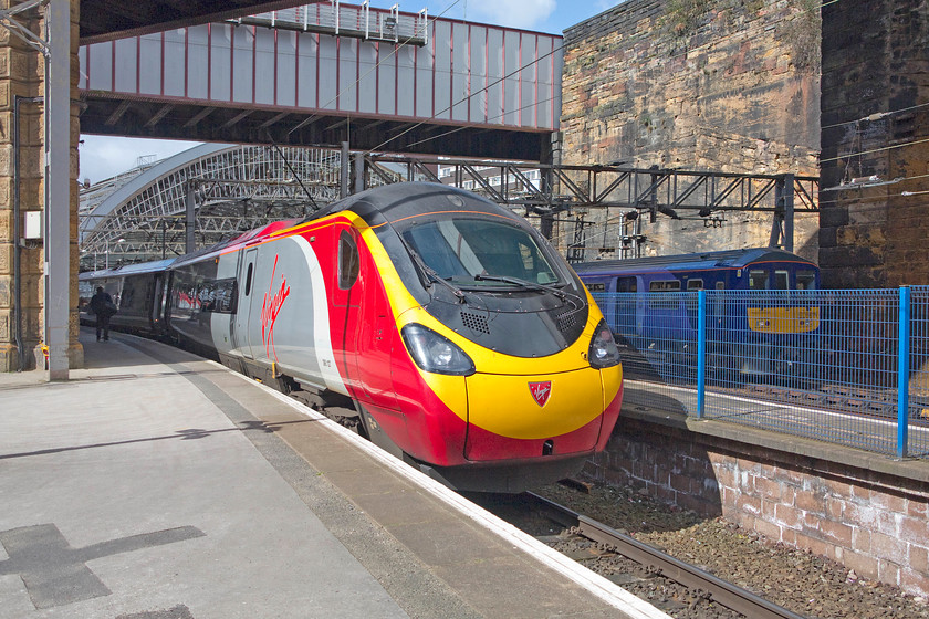 390107, VT 13.47 Liverpool Lime Street-London Euston (1A40) & 319378, NT 13.20 Liverpool Lime Street-Manchester Victoria (2J36), Liverpool Lime Street station 
 With one of Lime Street's huge arches in the background, 390107 waits to leave with the 1A40 13.47 to London Euston. Meanwhile, one of the recently refurbished electrics 319378 leaves with the 2J36 13.20 to Manchester Victoria. Lime Street was opened in August 1836 being designed by John Cunningham, Arthur Holme and John Foster Junior. It's the oldest 'grand' terminus station still in use throughout the world. 
 Keywords: 390107 13.47 Liverpool Lime Street-London Euston 1A40 319378 13.20 Liverpool Lime Street-Manchester Victoria 2J36 Liverpool Lime Street station