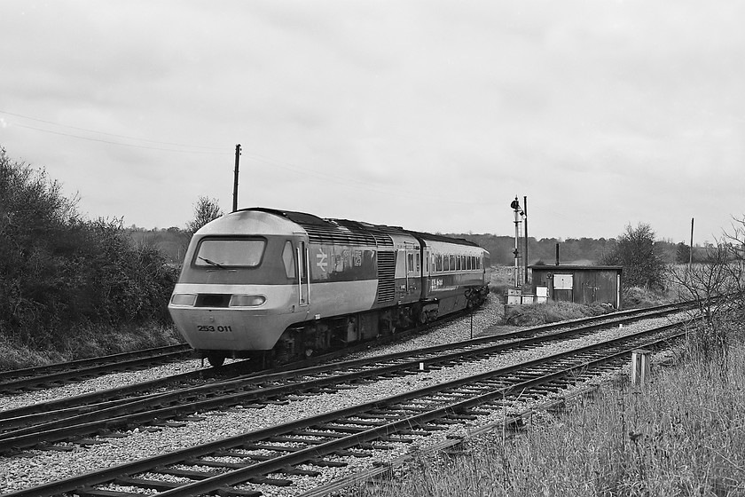 253011, unidnetified diverted up working, Bradford South Junction 
 HST set 253011 (either of 43022 or 43023) crosses Bradford South Junction working an unidentified up diversion to Paddington. From this point and for the next few miles or so the train will have been heading south and west that was actually away from its destination until it reached is Wesbury's Hawkeridge Junction where it will have head east once again via the Berks. and Hants. route to Reading. Ten years from when this photograph was taken the up line (the second one in) in the foreground was removed with the entire line to Thingley Junction singled and the semaphores were removed with control moving to the Westbury PSB. 
 Keywords: 253011 diverted up working Bradford South Junction HST 43022 43023