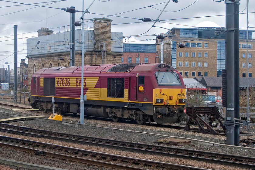 67028, stabled Thunderbird, Newcastle station 
 Station Thunderbird 67028 sits stabled to the south of Newcastle station waiting for the call to action! Behind the stabled locomotive is the former NER 1891 water tower. This structure is Grade II listed and at present is disused in the care of Network Rail. I think that it represents a superb opportunity for some sort of office or housing development. 
 Keywords: 67028 stabled Thunderbird Newcastle station