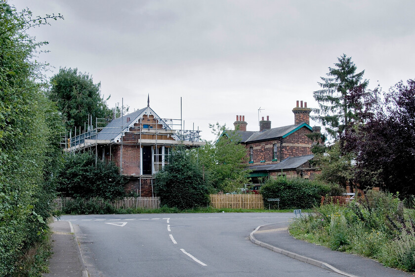 Former signal box, level crossing & station, Cowbit 
 A view that reveals much former railway infrastructure in the fenland village of Cowbit a short distance south of Spalding. To the left the former Great Eastern signal box dating from 1882 is seen undergoing a full restoration. The former station building that was closed on 11.09.61 is now converted into a private residence and a business. The old station waiting shelter on the up platform had been extended and turned into a dog grooming business. The new picket fence to the centre on Stonegate marks the spot of the level crossing. The last services ran, apart from the breakdown trains, through Cowbit in November 1982. 
 Keywords: Former signal box level crossing station Cowbit