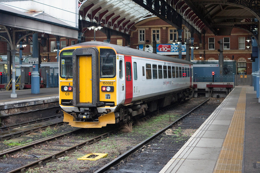 153322, stabled, Norwich station 
 One of Greater Anglia's single-car units, 153322, sits stabled under the overall roof of Norwich station. I like Norwich station, it's smart and, apart from the poor toilets, it has good facilities. Unfortunately, barriers have been installed so permission has be sought to get on the platforms. 
 Keywords: 153322 stabled Norwich station