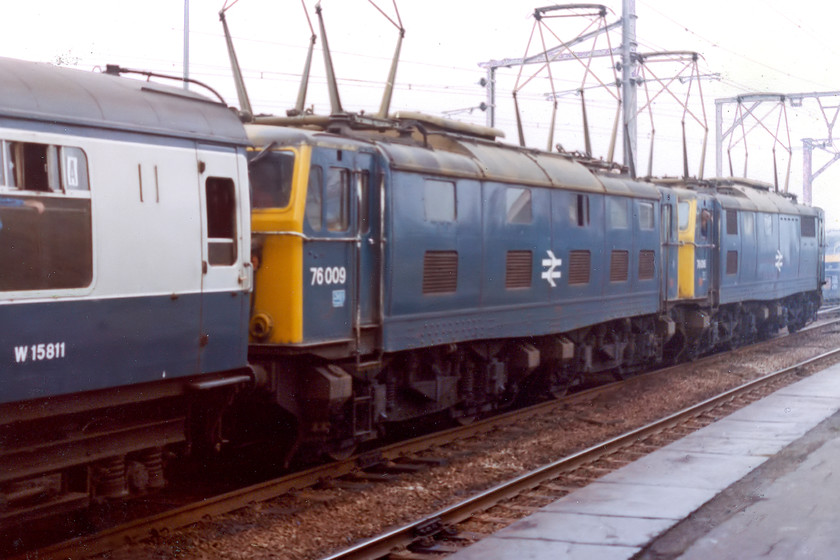 76016 & 76009, outward leg of the Pennine Explorer, Cardiff Central-Rotherwood, Penistone station (Courtesy of David Brush) 
 Another picture scanned from an original print kindly given to me by my teacher Mr. Brush who organised this trip for us lads. His image is the reverse angle of mine and shows 76016 and 76009 sitting at Penistone station. The doomed 1500V 76s are leading the Pennine Explorer railtour that has paused at the run-down Yorkshire station for a photo stop. Both these 76s made it to the end of the Woodhead route in July 1980 and both were cut up at C. F. Booth's scrapyard in Rotherham during 1983 having completed thirty years' of service. 
 Keywords: 76016 76009 Pennine Explorer Cardiff Central-Rotherwood Penistone station