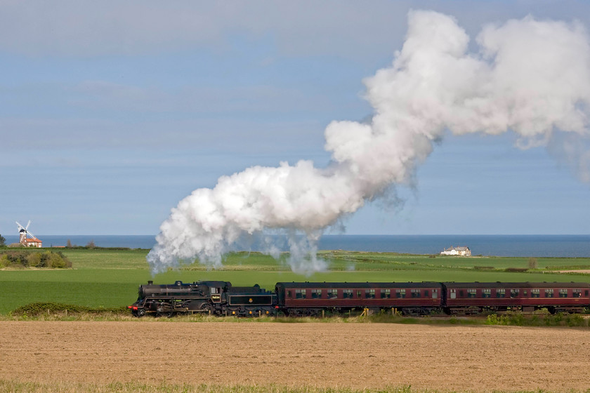 76034 (76084), 10.30 Sheringham-Holt, Weybourne Heath TG123423 
 As the previous photograph did not go quite to plan I decided to wait for the 10.30 Sheringham to Holt North Norfolk Railway service and try again. This time I opted for a slightly higher vantage point on Weybourne Heath and to include the North Sea. Whilst Class 4MT 76084 is better illuminated this time around the maroon stock has not fared so well being in the shadow of the exhaust; oh. well, you can't win them all! 
 Keywords: 76034 10.30 Sheringham-Holt Weybourne Heath TG123423 British Railways Standard Class 4MT 76084