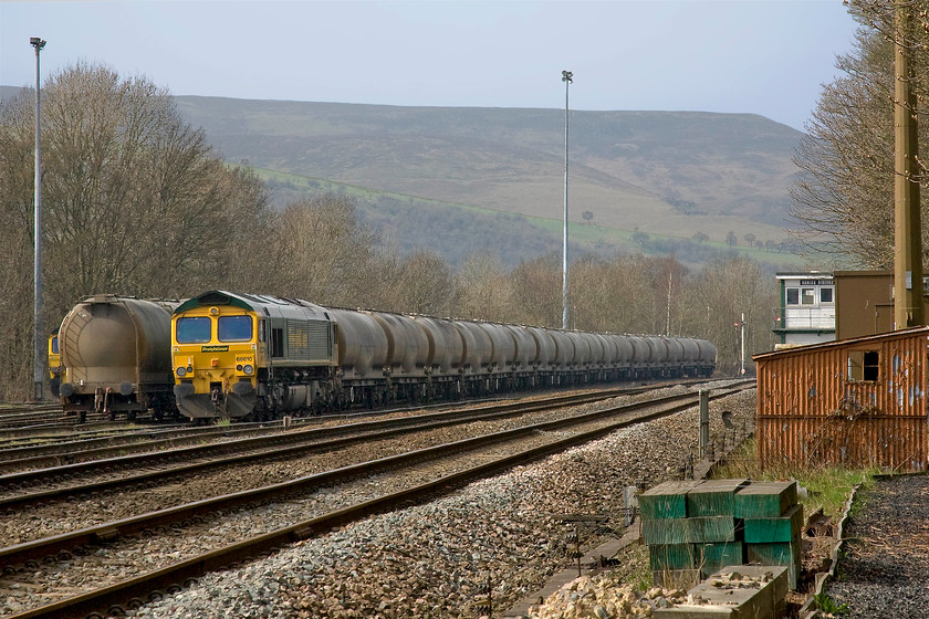 66610, stabled, Earles Sidings signal box (Midland, 1929) 
 A typical scene at Earles sidings with the bulk of Kinder Scout behind dominating the skyline. 66610 is seen at the head of a cement train with an unidentified classmate just out of sight to the left. To the far right of the image is Earles Sidings signal box, this is as close as I could get to it! Looking more like a British Railways 1960 style box it is, in fact, a 1929 Midland box that has been decapitated and then refurbished in 2005 with the usual UPVC cladding. 
 Keywords: 66610 Earles Sidings signal box