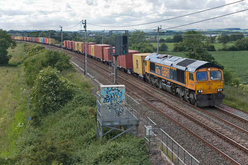 66726, 15.17 Hams Hall-Wembley Reception (4A47, 3L), Milton Crossing 
 With the slow lines closed through Northampton all traffic was diverted via the Weedon route. 66726 'Sheffield Wednesday' is seen passing Milton Crossing leading the 4A47 15.17 Hams Hall to Wembley Yard. Despite the cloudy sky there was actually quite a lot of sun about but it's just that it didn't shine down on the train! 
 Keywords: 66726 15.17 Hams Hall-Wembley Reception 4A47 Milton Crossing GBRf Sheffield Wednesday