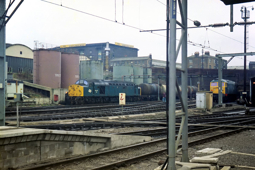 40057 & 47447, London Kings Cross stabling point 
 On arrival at King's Cross, the depot was disappointingly empty with just 40057 and 47447 on view with a total absence of Deltics. In the centre of this image, notice the railwayman calmly walking across the track work with no hi-viz; how things have changed! In preparation for in the inner suburban electrification, the electric masts and centenary have been installed and the platform extension work have been completed since my last visit. 
 Keywords: 40057 47447 London Kings Cross stabling point