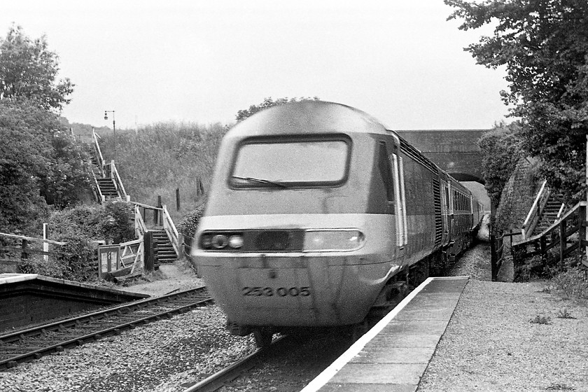 253005, unidentified diverted London Paddington working, Avoncliff station 
 253005 HST passes Avoncliff halt in the Avon Valley between Bath Spa and Bradford-on-Avon on a working to London Paddington. It's using this route due to a freight derailment closing the GWML at Challow. Trains ran up and down the Avon Valley, around the rarely used Westbury East Loop and then on the Berks and Hants route to and from Paddington. Notice the missing plastic cover from the running lights, a common feature of these class 43s just a year or so into their service. Thanks to Kevin Daniel for this information.