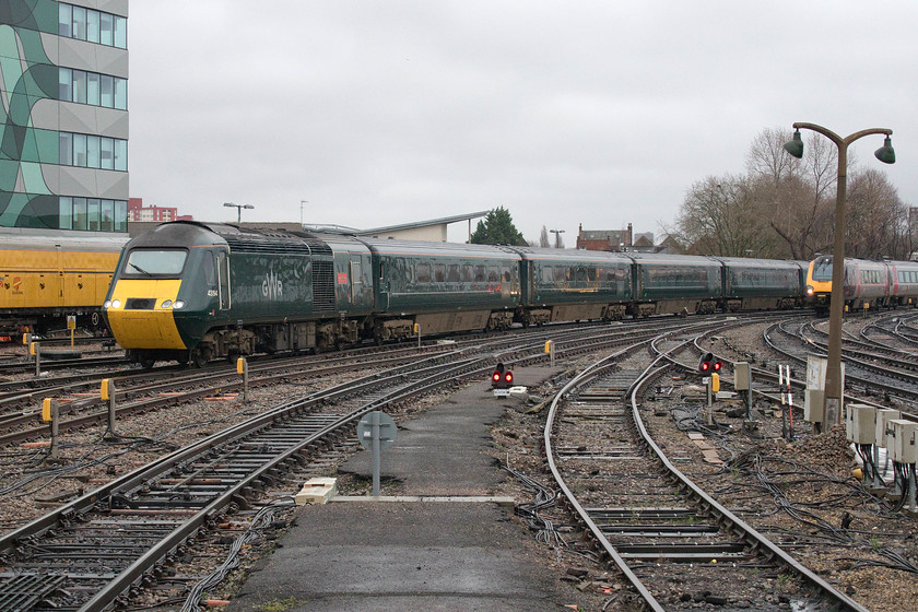 43194, GW 10.00 Cardiff Central-Taunton (2C71, 52L) cancelled from Bristol Temple Meads & 220023, XC 06.44 Newcastle-Plymouth (1V48, 2L), Bristol Temple Meads station 
 43194 'Oakhampton Castle' leads the extremely late (fifty-two minutes) 10.00 Cardiff to Taunton into Bristol Temple Meads with 220023 coming in alongside forming the 06.44 Newcastle to Plymouth. Whilst the Voyager carried on westwards and arrived only two minutes adrift, the HST was cancelled here at Bristol due to its very late arrival. The cause of the delay to and from South Wales was a failed train in the vicinity of the Severn Tunnel. These Class 255 Castle HST sets look superb with all credit to Great Western for keeping them in use on services replacing DMUs that are many years their junior; it's just a shame about the livery applied to them! 
 Keywords: 43194, GW 10.00 Cardiff Central-Taunton (2C71, 52L) cancelled from Bristol Temple Meads & 220023, XC 06.44 Newcastle-Plymouth (1V48, 2L), Bristol Temple Meads station Great Western Railway HST Voyager CrossCountry Oakhampton Castle class 255 castle class