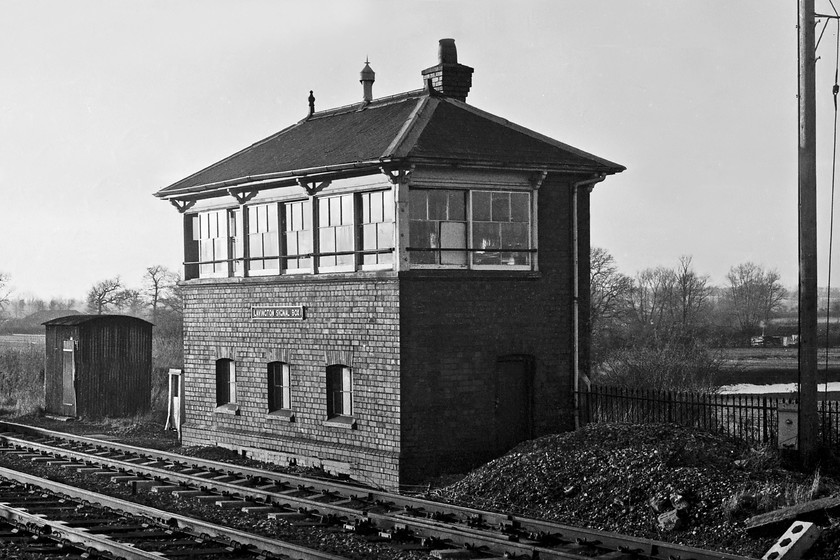 Lavington signal box (GW, c.1900) 
 Just catching the late afternoon dying rays of sunshine, Lavington signal box is seen. It is one of the Great Western's Type 7d boxes built with a hipped roof and with the classic three panes over two window arrangement. At this stage, Lavington box was half way through its final weekend of operation as it shut completely on the next Saturday night. It's interesting to note that the cast plate on the front of the box says 'Lavington' but it is actually situated close to the villages of Market and Great Lavington. So, I suppose to avoid upsetting the locals when the GW opened the station and box they chose the generic name. Incidentally, the station closed in April 1966. 
 Keywords: Lavington signal box