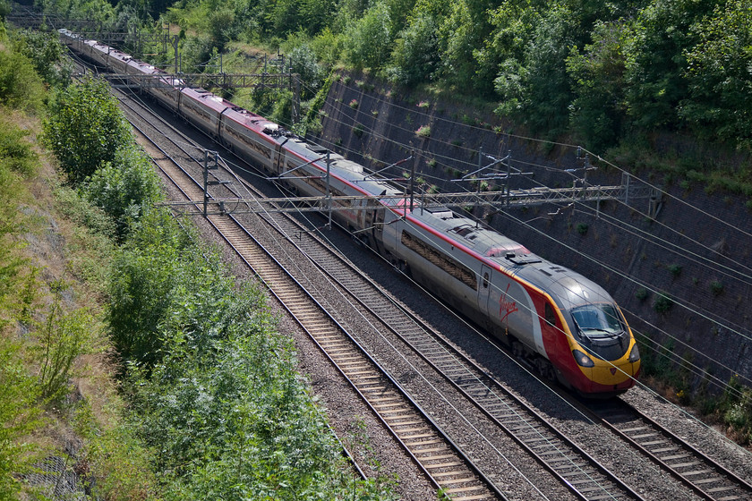 390124, VT 12.37 London Euston-Manchester Piccadilly (1H67, 6L), Roade Cutting 
 Heavily back-lit but any opportunity to capture a class 390 is it original as-built livery is taken as there were an increasingly fewer number by the summer of 2018. Here, 390124 'City of Preston' passes north through Roade Cutting working the 12.37 Euston to Manchester Piccadilly. 
 Keywords: 390124 1H67 Roade Cutting