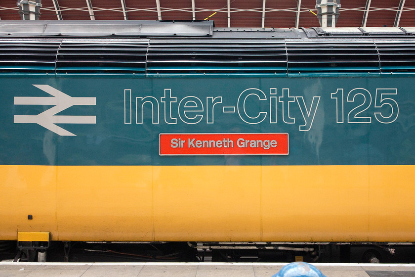 Nameplate & decals, 43002 (253001), GW 16.00 London Paddington-Bristol Temple Meads (1C21), London Paddington station 
 A picture reminiscent of times gone by. When the HST was launched to the travelling public in 1976 this is how they saw the power cars. Apart from the Inter-City Swallow livery, this is how they stayed until the plethora of liveries abounded under privatisation. Proudly displaying its 'Sir Kenneth Grange' nameplates (the designer of the HST), 43002 sits at the back of the 16.00 to Bristol Temple Meads at Paddington station. 
 Keywords: 43002 253001 16.00 London Paddington-Bristol Temple Meads 1C21 London Paddington station