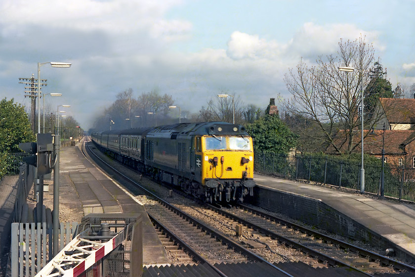 50043, unidentified down working, Kintbury station 
 My records have this as 50043 'Eagle' shattering the peace at Kintbury station heading west with an unidentified down working. However, I think something is amiss as, according to contemporary information, 50043 was not named until June 1978 and in this image red plates are clearly seen on the bodyside. So, I think that my records are possibly incorrect? The image is taken from the top of steps of Kintbury signal box that we had been invited into. Kintbury signal box was about to close with the opening of a new portacabin type structure (still open in 2018) renamed Kintbury Crossing Box. This new structure simply controlled the CCTV monitored crossings at Hamstead and Kintbury leaving a long block section between Newbury West and Hungerford that was only in-place for a short time prior to new MAS being introduced. 
 Keywords: 50043 unidentified down working Kintbury station