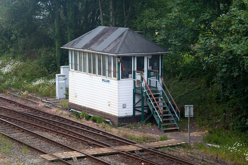 Millom signal box (Furness, 1891) 
 The 1891 Millom signal box is tricky to photograph at close quarters and is somewhat different now than originally built due to more recent modernisation such as steel steps and UPVC cladding. The box was rebuilt in 1913 following complete destruction by a runaway train that derailed, the cause was put down to wet rails but in all probability was the old favourite 'leaves on the line'! To capture this image over a very high bridge parapet I had to resort to the use of my trusty step ladder. 
 Keywords: Millom signal box Furness 1891