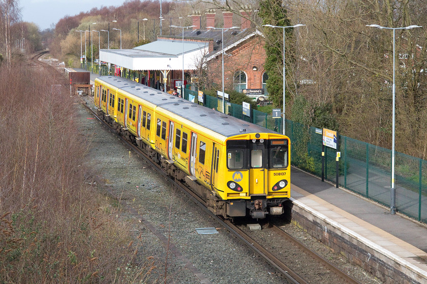 508137, MR 16.40 Liverpool Central-Ormskirk (2O42), Derby Street bridge, Ormskirk 
 Orsmkirk station was 'split' in 1970 following the withdrawal of direct Liverpool to Preston trains via Rufford. This crazy situation still exists today but there is continued talk of plans to overcome and improve this rather silly situation. The buffers marking the divide between the Merseyrail and Northern lines can be seen just in front of 508137 that has just arrived with the 16.40 from Liverpool Central. 
 Keywords: 508137 16.40 Liverpool Central-Ormskirk 2O42 Derby Street bridge, Ormskirk