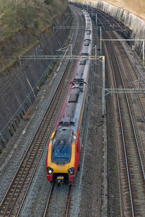 Class 221s, VT 14.35 Chester-London Euston (1A43, 2L), Roade cutting 
 Given the low passenger numbers on the railways, running at about fifteen per cent of normal, I am surprised that Avanti West Coast are operating a pair of Class 221s on this 14.35 Chester to Euston service. I suppose it will mean that those making the journey can manage their social distancing easily on-board. The train is seen entering Roade cutting from the northern end. 
 Keywords: Class 221s 14.35 Chester-London Euston 1A43 Roade cutting Avanti West Coast Voyager