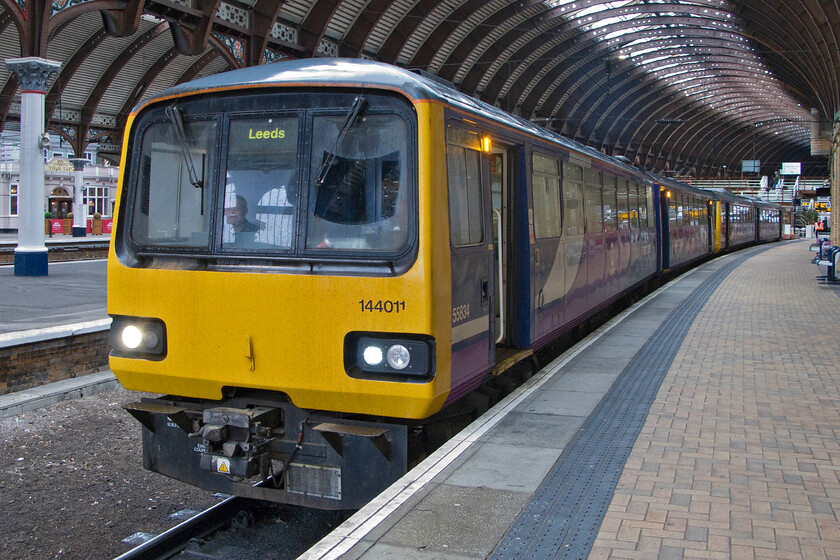 144011, NT 10.11 York-Leeds (2C21), York station 
 My wife, son and I enjoyed a little Pacer action by taking 144011 from York to Harrogate. The 10.11 York to Leeds 2C21 waits to depart under the grand curved roof of York station that was currently protecting us from the teaming rain. The 'nodding donkey' ride characteristics of the Pacers was most noticeable on the sections of ancient jointed track between Skelton Junction and Knaresborough. 
 Keywords: 144011 10.11 York-Leeds 2C21 York station Northern Pacer