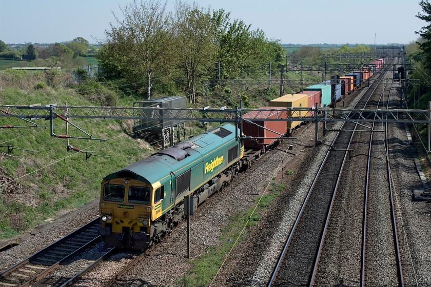 66546, 09.25 Southampton MCT-Garston (4M28, 7E), Victoria bridge 
 Freightliner 66546 leads the long and heavily laden 09.25 Southampton to Garston 4M28 working on the southern section of the WCML between Roade and Ashton. I am always somewhat surprised that this particular working uses the busy WCML corridor that necessitates it crossing north London rather than going via the GW route through Didcot, Oxford and Banbury. 
 Keywords: 66546 09.25 Southampton MCT-Garston 4M28 Victoria bridge Freightliner