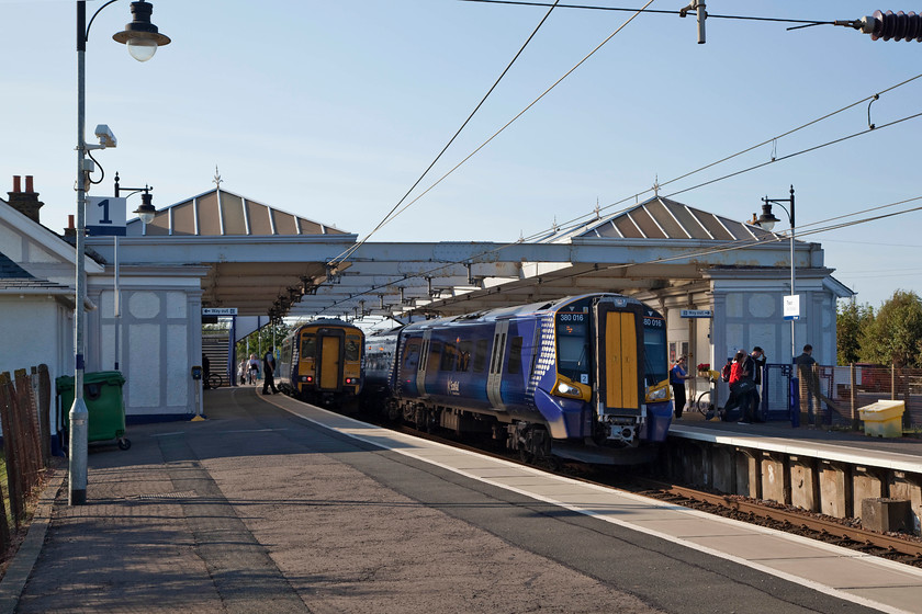 156462, SR 16.59 Stranraer-Glasgow Central (1A03, 4L), & 380016, SR 17.47 Glasgow Central-Ayr (1K49, 3L), Troon station 
 156462 pauses at Troon station working the 16.59 Stranraer to Glasgow Central. Just arriving on platform two is 380016 forming the 17.47 Glasgow Central to Ayr. There is a regular four trains per hour service to and from Glasgow. 
 Keywords: 156462 1A03 380016 1K49 Troon station