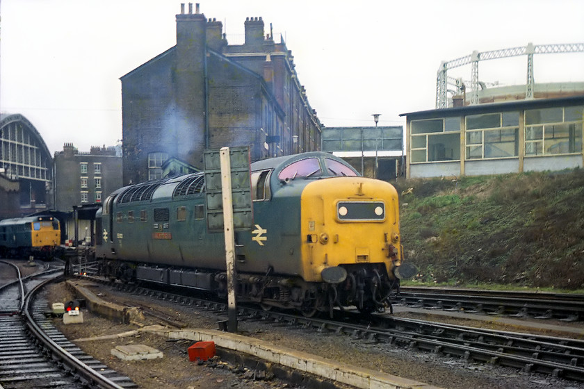 55022, moving on to 11.00 London Kings Cross-Edinburgh (1S21), London Kings Cross station 
 A photograph full of interest and one that is instantly recognisable for its location. 55022 'Royal Scots Grey' comes off-shed by making a number of movements over the complicated network of track in the foreground to then attach to the front of the 1S21 11.00 to Edinburgh. In the background is Scot and Barlow's instantly recognisable train shed and one of the gasometers that were a familiar site as you entered St. Pancras station on the Midland. One of King's Cross' station pilot class 31s can be seen awaiting its next turn of duty. 
 Keywords: 55022 11.00 London Kings Cross-Edinburgh 1S21 London Kings Cross station