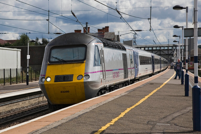 43299, GR 12.00 London King's Cross-Inverness, 'The Highland Chieftain' (1S16), Grantham station 
 Passing through Grantham at full line speed my second titled train of the day is seen led by 43299. The HST is working the 12.00 King's Cross to Aberdeen that East Coast title 'The Highland Cheiftan'. Notice that the other enthusiast seen and I are standing well back behind the yellow line both to avoid incurring the wrath of station staff and spooking the driver. 
 Keywords: 43299 12.00 London King's Cross-Inverness The Highland Chieftain 1S16 Grantham station East Coast HST