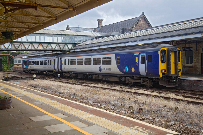 156483, NT 11.11 Carlisle-Barrow-in-Furness (5C50, 9E), Workington station 
 The 11.11 Carlisle to Barrow-in-Furness Northern service arrives at Workington station worked by 156483. It has just passed the unusually located 1886 LNWR Type 4+ signal box. Also, notice the ground disc signals - the left two of which are no longer in use with the tracks all but lifted. 
 Keywords: 156483 11.11 Carlisle-Barrow-in-Furness 5C50 Workington station Northern