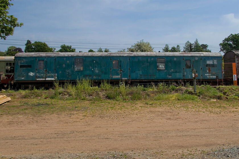 M94071, stabled, Pitsford Yard 
 Built at York (underframe) and St. Rollox (body and assembly) in 1958 GUV (General Utility Van) was a Midland-allocated vehicle. However, the nature of these GUVs meant that they were found and ended up all over the country. At some time in its life, it became a newspaper van and had ceiling-mounted heating added. Ending its career allocated to Bristol Marsh Junction it was withdrawn in 1995 seeing just under forty years in service. It is a long-term resident of the Northampton and Lamport Railway having arrived the year after its withdrawal in 1996 and is used for general storage. 
 Keywords: M94071 stabled Pitsford Yard