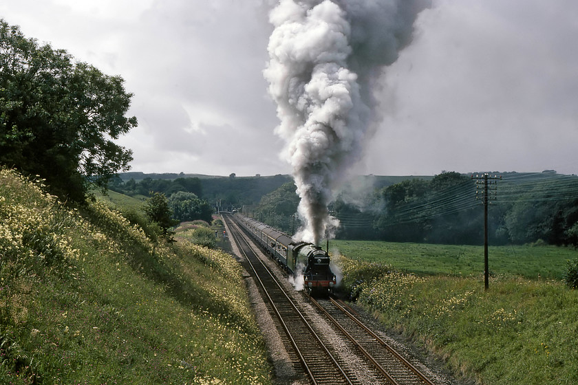 4472, outward leg of The North Yorkshireman, Carnforth-Skipton, Wennington SO625700 
 4472 'Flying Scotsman' gets The North Yorkshireman away from Wennington station after some dramatic slips. I'm not too sure how high the exhaust is in the air above the locomotive but I suspect it could be seen from a fair distance around the area! Notice my railway companions, Graham and David, on the land once occupied by the loop and sidings. Graham had just taken the previous image ..... https://www.ontheupfast.com/v/photos/21936chg/26751472604/x4472-north-yorkshireman-carnforth 
 Keywords: 4472, outward leg of The North Yorkshireman, Carnforth-Skipton, Wennington SO625700