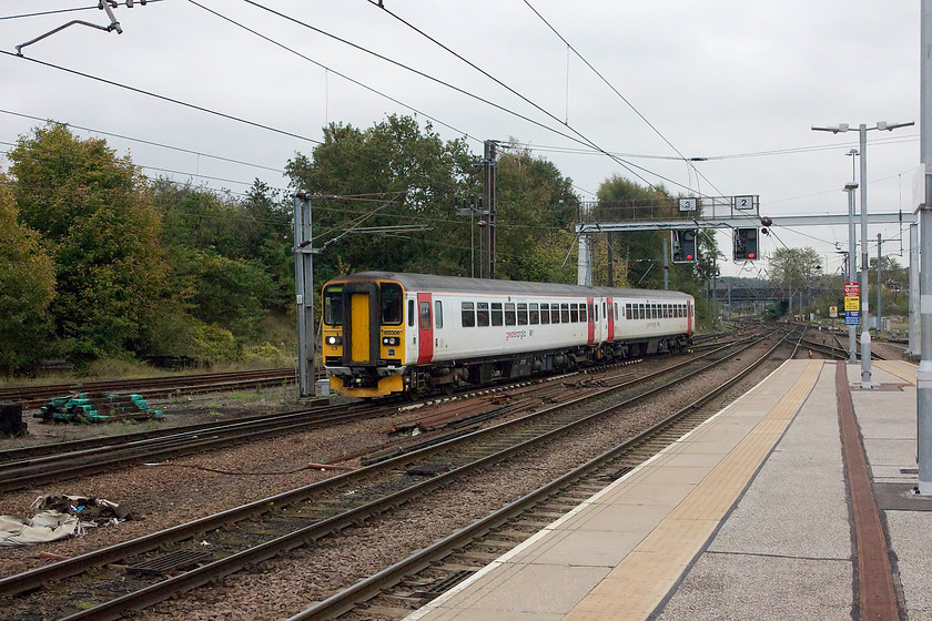 153306 & class 153, 15.30 Norwich Crown Point-Norwich ECS (5S24), Norwich station 
 Two class 153 single car DMUs, with 153306 leading, arrive into Norwich station having made the short journey from Crown Point as 5S24. On a drab autumn day, the Greater Anglia livery certainly stands out and brightens things up a bit! 
 Keywords: 153306 class 153 15.30 Norwich Crown Point-Norwich ECS 5S24 Norwich station