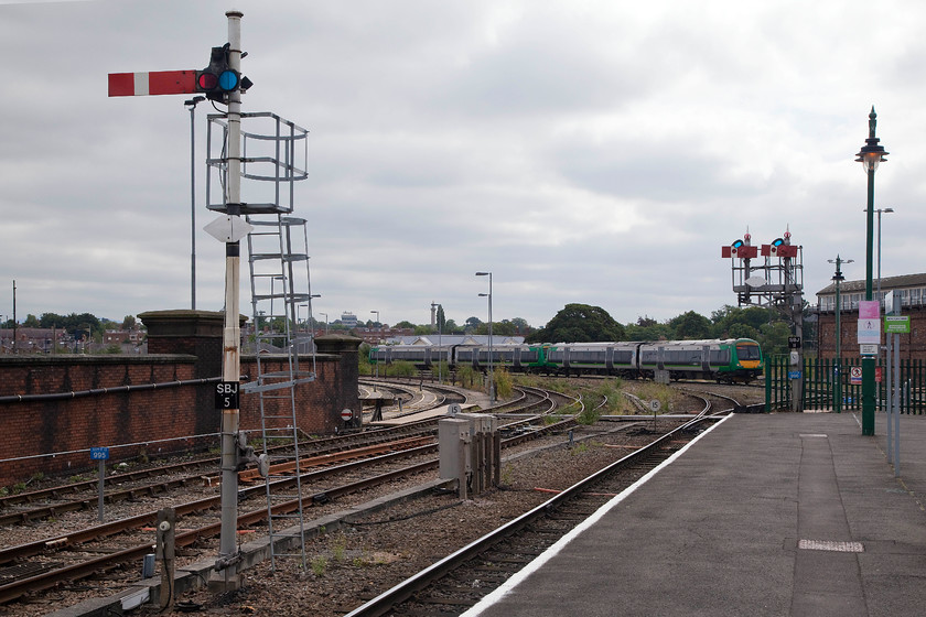 170501 & 170509, LM 11.05 Birmingham New Street-Shrewsbury (1J12), Shrewsbury station 
 Vintage signalling is still in operation at Shrewsbury and no more so than at the up end of the station. To the left is SBJ5 up main home for Severn Bridge Junction and to the right SBJ11, the up main home for Severn Bridge Junction. This is an unusual signal as both arms are wooden centre pivoting type with unique placing of the spectacles. These dwarf arms are usually used where space is a problem, such as on Worcester Foregate station, quite why they were installed here remains a mystery where there's plenty of room. In the background, 170501 and 170509 approach Shrewsbury with the 11.05 from Birmingham New Street. 
 Keywords: 170501 170509 11.05 Birmingham New Street-Shrewsbury 1J12 Shrewsbury station