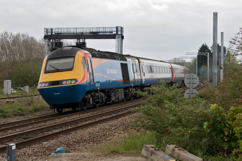 43046, EM 10.30 Nottingham-London St. Pancras (1B36, RT), Wellingborough south 
 Taken from the station car park, 43046 brings up the rear of the 10.30 Nottingham to London St. Pancras as it leaves Wellingborough. Notice the electrification masts that have finally arrived within the vicinity of the station and the huge new signal gantry for the slow lines. 43046 was delivered new to the Western Region in the summer of 1977 initially being part of set 253023. 
 Keywords: 43046 10.30 Nottingham-London St. Pancras 1B36 Wellingborough south