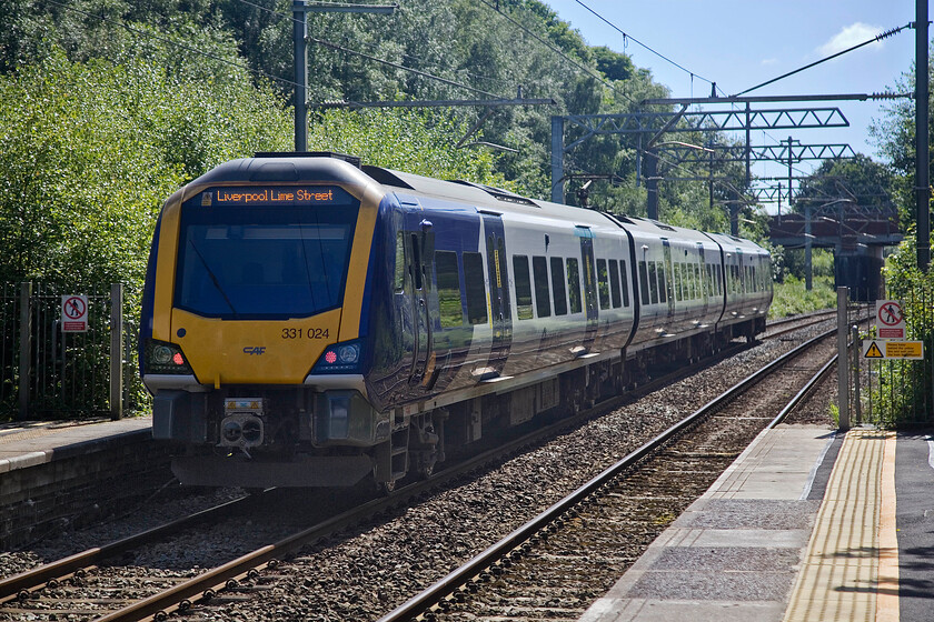 331024, NT 15.53 Wigan North Western-Liverpool Lime Street (2C21, 1E), Bryn station 
 And so we come to the final photograph of our epic three-day trip to Cumbria. Setting off into the afternoon sunshine, 331024 departs from Bryn station with Northern's 2C21 15.53 Wigan North Western to Liverpool Lime Street service. Back to the car now and the small matter of a one hundred and fifty-miles journey back to Northamptonshire! Here's to our next trip out. 
 Keywords: 331024 15.53 Wigan North Western-Liverpool Lime Street 2C21 Bryn station Northern