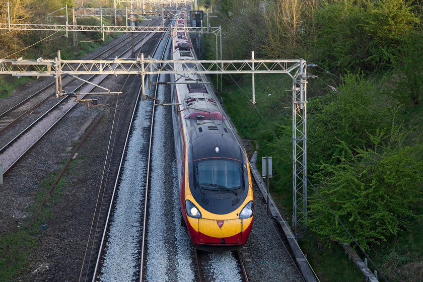 390136, VT 18.34 London Euston-Liverpool LS (1F25, 10L), Victoria Bridge 
 There has been recent ballast work at Victoria Bridge by the look of it. Victoria Bridge is a smashing spot on the southern West Coast Mainline near to Roade in Northamptonshire. In this evening view, 390136 'City of Coventry' is about to pass under the bridge forming the 18.34 Euston to Liverpool Lime Street. This working will not pass through its namesake but take the Trent Valley line through Nuneaton, Tamworth and then to Stafford. 
 Keywords: 390136 1F25 Victoria Bridge