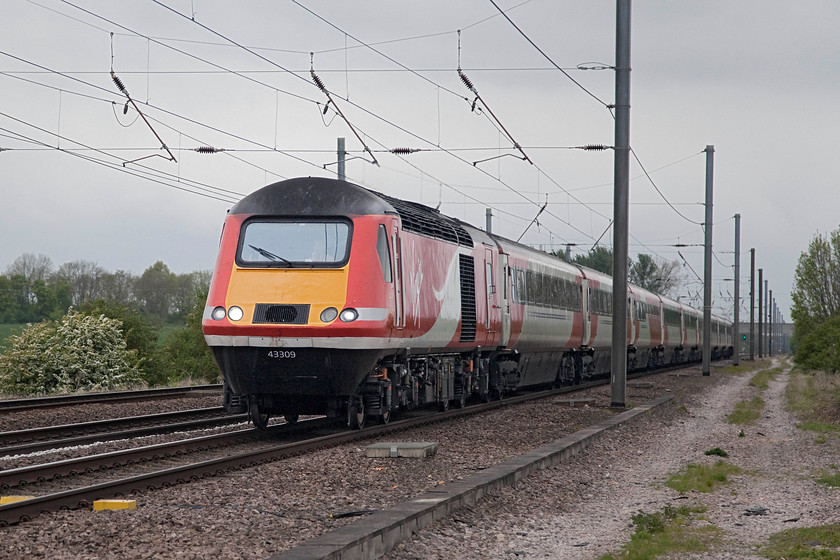 43309, GR 08.30 Edinburgh-London Kings Cross (1E07, 2E), White House Crossing TL227777 
 A sight that, 40 years ago, I would have turned away from with some distain. An HST on the ECML meant that another Deltic turn had gone leading to their ultimate demise. How ironic then that now it's the HST that is the photographed train and the one threatened! Here, 43309 leads the 08.30 Edinburgh to London King's Cross past White House Crossing just north of Huntingdon. 43309 has been an Eastern Region unit all its life, originally as 43109 it was part of set 254027. 
 Keywords: 43309 1E07 White House Crossing TL227777