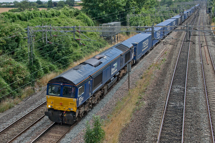 66431, 10.02 Tilbury-DIRFT (4M07, 24E), Victoria bridge 
 A well-loaded 4M07 Tesco train passes Victoria bridge in south Northamptonshire about twenty miles from its destination at the Daventry International Railfreight Terminal (DIRFT). The 10.02 ex Tilbury docks is led by 66431 which is one of DRS' locomotives that I have very few photographs of. 
 Keywords: 66431 10.02 Tilbury-DIRFT 4M07 Victoria bridge DRS Direct Rail Services