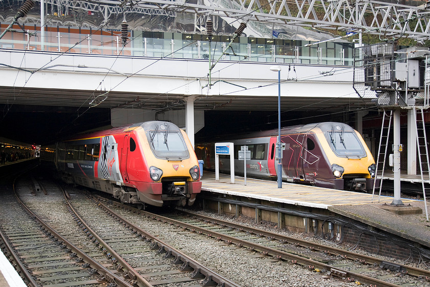 221115, VT 13.20 Birmingham New Street-Preston (2S65) & 221140, XC 11.27 Manchester Piccadilly-Eastleigh (1O16), Birmingham New Street station 
 A pair of class 221 Voyagers stand cheek by jowl at Birmingham New Street station. To the left Virgin Trains' 221115 'Polmadie Depot' waits to leave with the 13.20 to Preston. Whilst, to the right is Cross Country's 221140 waiting to head out south with the 11.27 Manchester Piccadilly to Eastleigh. Termination at this Hampshire station was because of Sunday engineering works. 
 Keywords: 221115 13.20 Birmingham New Street-Preston 2S65 221140 11.27 Manchester Piccadilly-Eastleigh 1O16 Birmingham New Street station