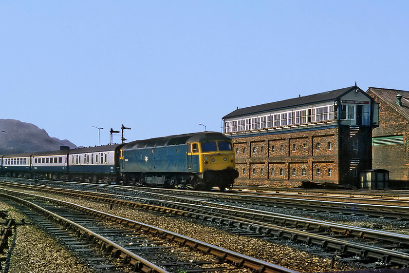 47439, 13.29 Holyhead-London Euston, Llandudno Junction 
 The 13.29 Holyhead to Euston service approaches Llandudno Junction passing the substantial box of the same name hauled by 47439. The Cass 47 would probably have hauled the train as far as Crewe (or possibly Birmingham New Street) where an AC electric would take over. These services between Holyhead (and/or Bangor) and London still run today but, at the time of writing, they are operated by the unloved and tired Voyagers soon to be replaced by thirteen Hitachi bi-mode Class 805s the first of which is undergoing dynamic testing. 
 Keywords: 47439 13.29 Holyhead-London Euston Llandudno Junction