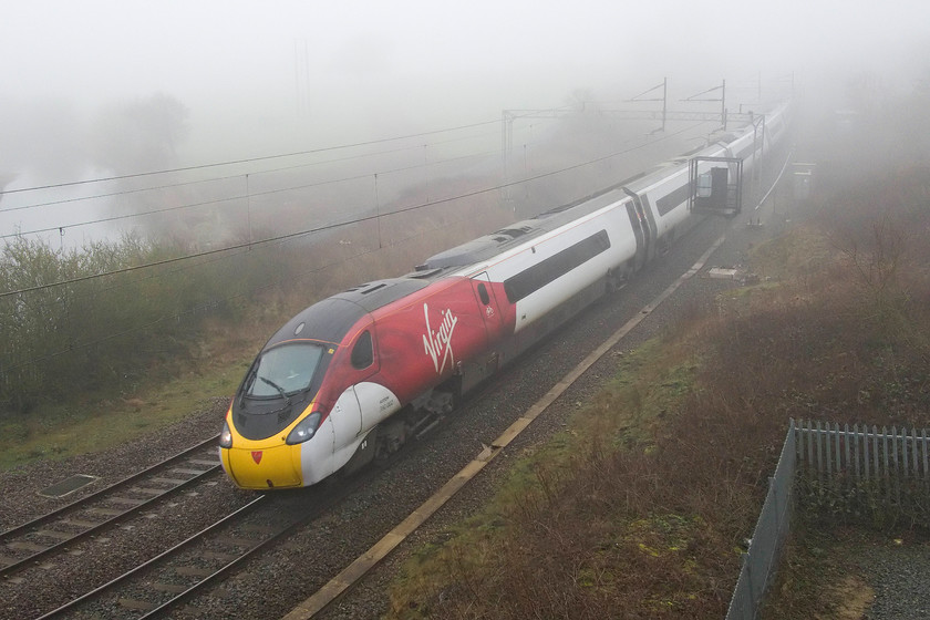 390002, VT 07.30 London Euston-Glasgow Central (1S42, 10L), A45 Weedon bypass bridge 
 390002 'Stephen Sutton' is about to pass under the A45 Weedon bypass bridge just to the north of the village with the 07.30 Euston to Glasgow Central. Despite the foggy conditions, the water of the Grand Union canal can just be seen in the top left of the picture. 
 Keywords: 390002 07.30 London Euston-Glasgow Central 1S42 A45 Weedon bypass bridge