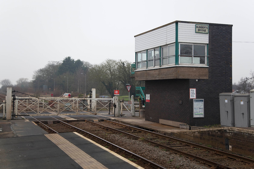 Hubberts Bridge Signal Box (BR, 1961) & crossing gates 
 Despite Hubberts Bridge station having few facilties, it does have a signal box. It is not a pretty structure being built by BR in 1961. The crossing gates are still manually controlled by the signalman. This box replaced a magnificent structure that stood on the same spot until it was replaced in the early 1960s. 
 Keywords: Hubberts Bridge Signal Box 1961 crossing gates