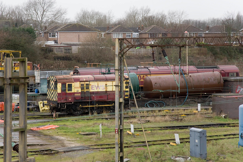 08888 & 66042, stabled, Bescot Yard 
 Shunter, 08888 looks sorry for itself in Bescot Yard. According to data on the internet, it is still operational and not withdrawn. It's EWS livery looks very faded, not like 66042 behind it stabled on one of the shed roads. 
 Keywords: 08888 66042 stabled Bescot Yard