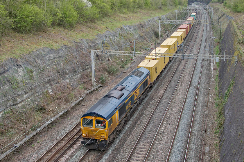 66785, 12.34 Wembley Reception Sidings-Hams Hall (4G13, 9E), Roade cutting 
 Hooray: A photographic cop! I have been trying to get pictures of a small batch of higher-numbered Class 66s but they have evaded my lens but not today. Imported from Sweden, adapted and entering service for GBRf in 2019, 66785 leads the 4G13 12.34 Wembley to Hams Hall service through Roade cutting. 
 Keywords: 66785 12.34 Wembley Reception Sidings-Hams Hall 4G13 Roade cutting GBRf