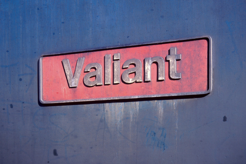 Nameplate, 50015, Westbury MPD 
 With the side looking a little faded and work stained, 50015 'Valiant' sits in the morning sun on Westbury depot. The Class 50 was 'knackered' according to a member of staff who allowed us to walk around the depot with impunity. Named two years previously, 50015 would soldier on for another four months, no doubt failing on numerous other occasions, before being sent north to Doncaster for its refurbishment. 
 Keywords: Nameplate 50015 Westbury MPD Valiant