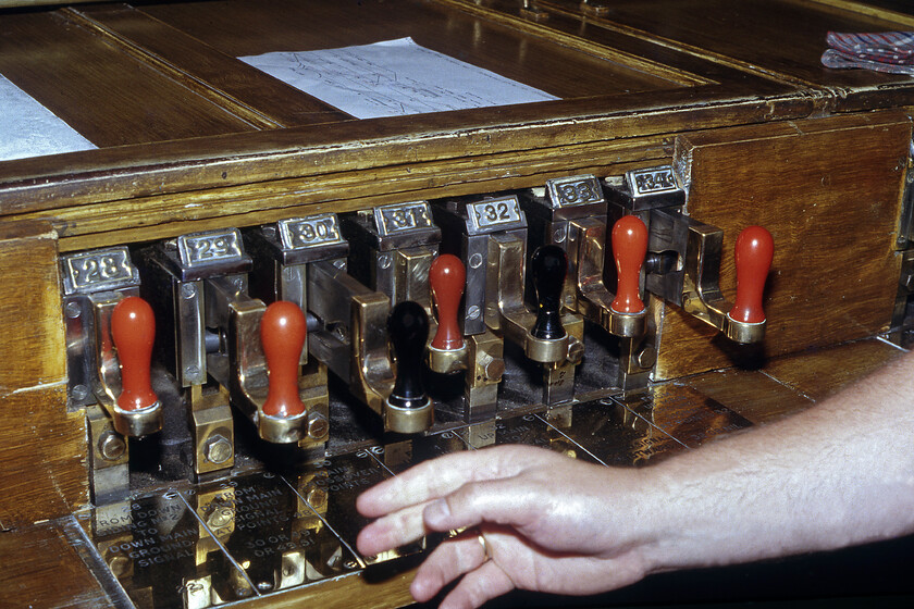 Signals being pulled off in Salisbury West signal box 
 The signalman inside Salisbury West box operates the slides that in turn actuate the signals and pointwork. The electro-pneumatic system was an experiment by the L&SWR that was tried at a number of other locations on their network but was one that was not widely adopted. This system of signalling in the Salisbury area had just a week left in operation from when this photograph was taken to be replaced by conventional multi-aspect colour lights operated from a panel installed on the station's platform two. 
 Keywords: Signals being pulled off in Salisbury West signal box