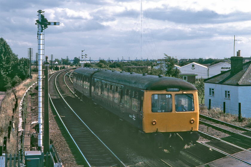 Class 105 DMU, 14.10 Cambridge-Peterborough, March South signal box 
 A two-car Class 105 DMU approaches March taken from the window of the South Signal box. The first generation DMU was working the 14.10 Cambridge to Peterborough service with passengers no doubt bouncing up and down on the softly sprung seats as it crossed the undulating Fenland track. 
 Keywords: Class 105 DMU 14.10 Cambridge-Peterborough March South signal box First generation DMU