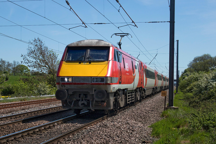 91109, GR 12.33 London King`s Cross-Leeds (1A30, RT), Hough Lane SK860485 
 91109 'Sir Bobby Robson' is at full line speed passing Hough Lane crossing south of Claypole. The powerful and soon to be replaced class 91 is leading the 1A30 12.33 King's Cross to Leeds. This was the first class 91 to be re-named when the last but one operator, East Coast, resumed a naming policy following its predecessor's, National Express East Coast, decision to de-name all their stock. 
 Keywords: 91109 12.33 London King`s Cross-Leeds 1A30 Hough Lane SK860485