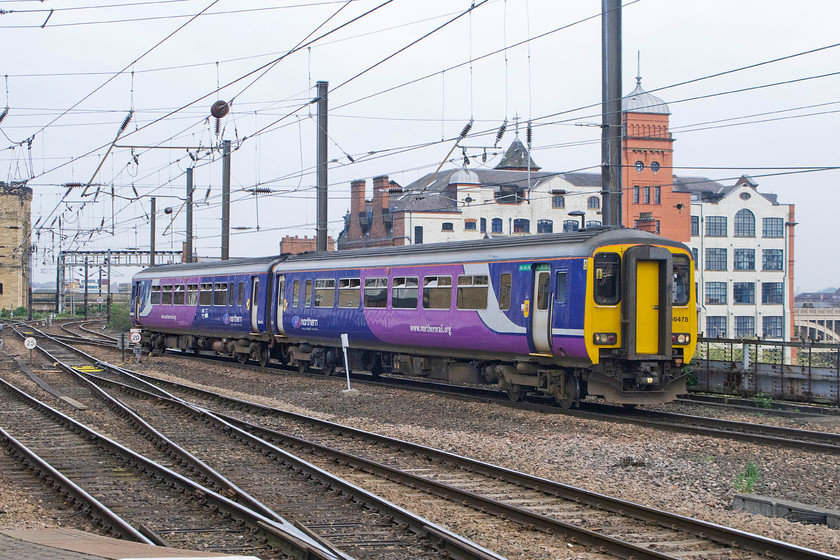 156475, NT 14.18 Nunthorpe-Hexham (2N39), Newcastle station 
 156475 has just crossed the High Level bridge and is about to enter Newcastle station where it will pause whilst working the 14.18 Nunthorpe to Hexham service. Behind the Super Sprinter is the Turnbull building striking a dramatic pose between the railway and the River Tyne below to its right. This impressive structure was built in 1890 and occupied by the printers R. Robinson & Co. In 1963 it was taken over by Messrs E. & F. Turnbull, a Newcastle-based ironmonger, who used it as a wholesale warehouse and who gave the building its present-day name. Finally, in 2002 it was converted into luxury 'loft' type apartments, whatever they are supposed to be! 
 Keywords: 156475 14.18 Nunthorpe-Hexham 2N39 Newcastle station Northern Trains